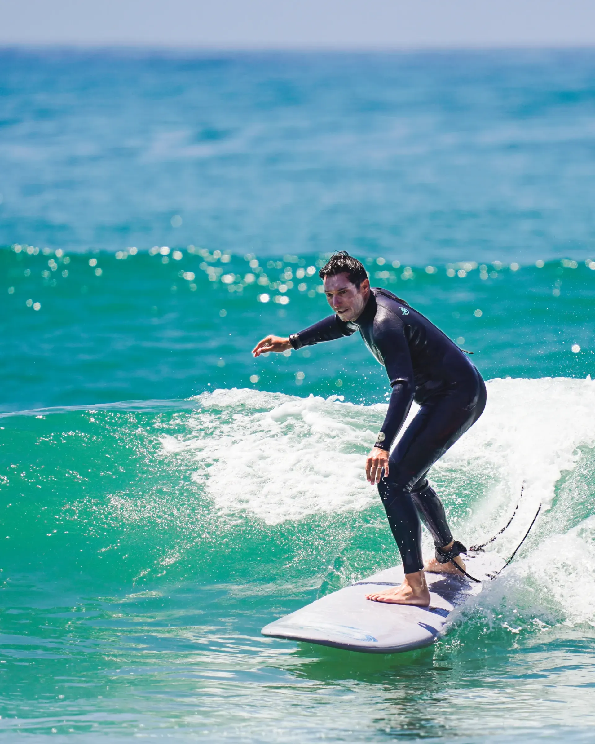Surfer riding a wave at Moroccan surf camp in Imsouane.