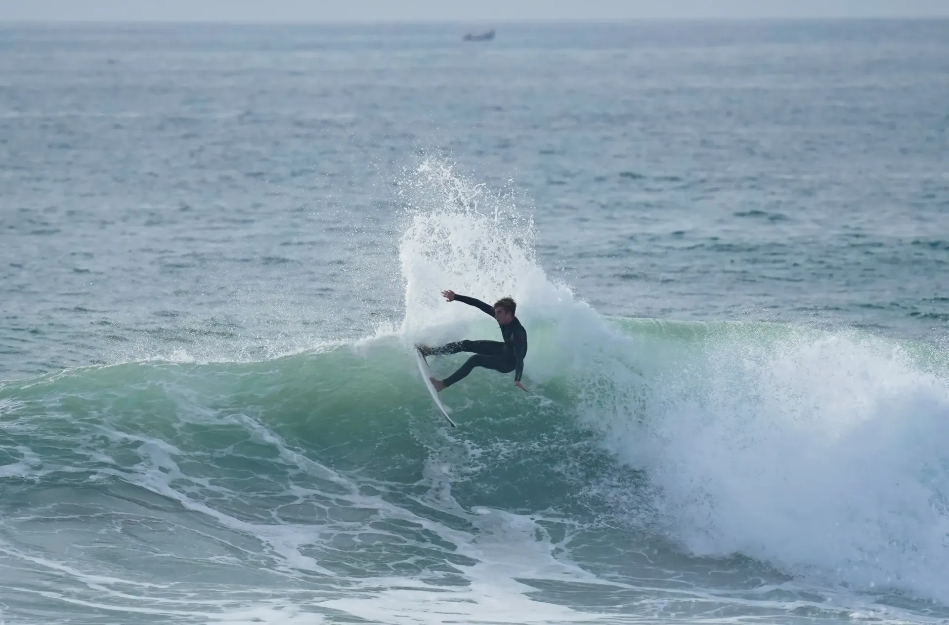 Surfer riding a wave at Imsouane surf camp in Morocco.