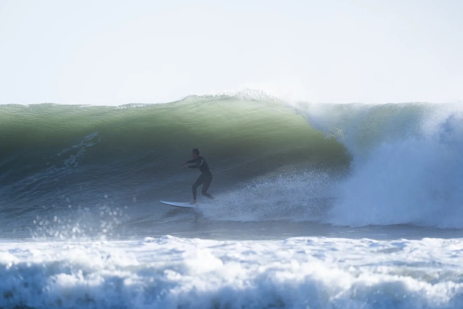 Surfer riding a large wave at Imsouane, Morocco, showcasing excitement and skill.
